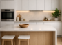 Minimalistic kitchen design with white cabinets, wooden accents, clean countertops, and soft natural lighting creating a modern and amazing look